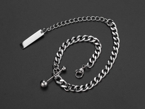 Detail of silver stainless steel Cuban chain bracelet with rectangular tag and metal bead