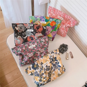 Flat lay of vintage floral cotton cosmetic bags with five patterns and zippers