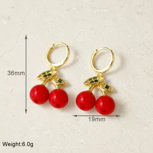 Detail view of red cherry earrings with gold leaf and dimensions 36mm by 19mm