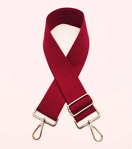 Detail of adjustable wine red wide shoulder strap with golden metal swivel hooks
