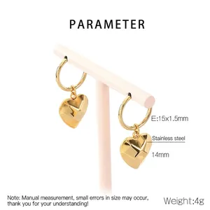Detail view of 14mm 3D heart charms on 15mm gold-tone stainless steel hoop earrings
