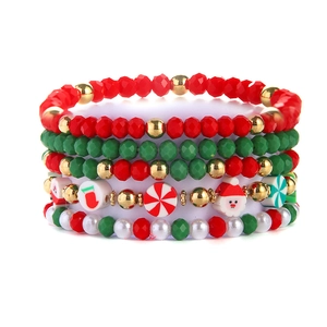 Detailed view of 5-piece Christmas beaded bracelet set with Santa and holiday charms