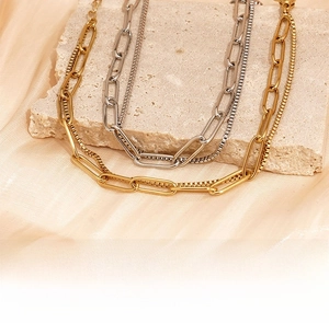 Close-up of double-layered titanium steel chain bracelets in gold and silver finishes