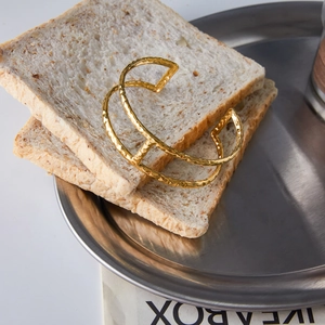 Detailed view of gold 18K stainless steel cuff bracelet with hammered texture finish