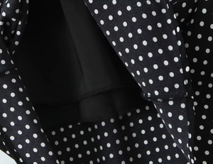 Close-up of black and white polka dot dress showing high-quality inner lining and stitching