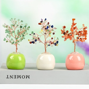 Three handmade colorful crystal money trees on books for creative home and office decor