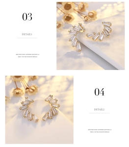 Macro detail of crescent zircon earrings in gold finish with rectangular cut stones
