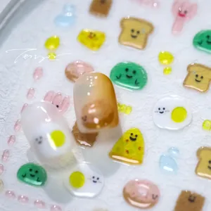 Detailed macro view of 3D gummy bear and food-shaped nail art stickers on display