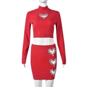 Detail of red ribbed crop top and mini skirt set with rhinestone heart cut-outs