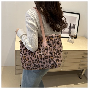 Close-up of leopard print plush tote bag with soft faux fur texture and leather straps
