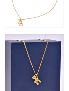 Detailed view of a 3D teddy bear pendant with polished 18k gold finish on a fine chain