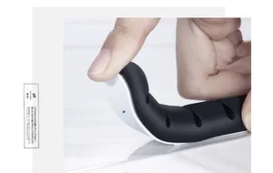 Flexible black silicone cable organizer with strong adhesive backing showing high elasticity