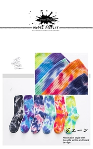 Detail showing the rib-knit cuffs and tie-dye cotton fabric texture of mid-tube crew socks