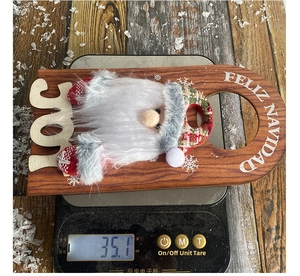 Close-up of a Christmas gnome wooden door hanger with JOY text weighing 35.1 grams