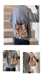 Close-up of leopard print faux fur bucket bag with pink straps and pearl drawstring detail
