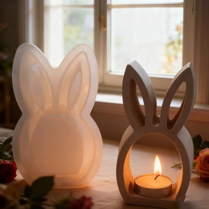 Detailed view of hollow bunny silicone mold and finished plaster candle holder with tea light