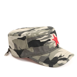 Detail view of camouflage military cap featuring a red star embroidery on canvas fabric