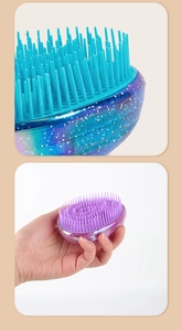 Close-up of glittery blue and pink portable hair combs showing bristles and compact size