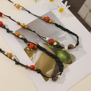 Detail of bohemian waist rope with ethnic wooden beads and black braided cord texture