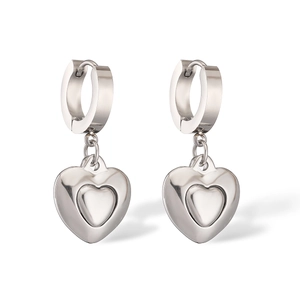 Detail view of double layered silver heart pendants on huggie hoop earrings