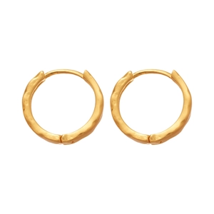 Minimalist golden round hoop earrings with irregular hammered texture on white background