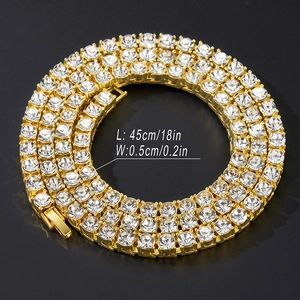 Detailed view of triple row rhinestone tennis chain with gold finish and fold-over clasp