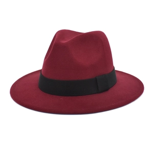Detail view of burgundy wool fedora hat with a black grosgrain ribbon band and flat brim