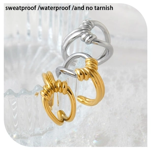 Detailed macro view of gold and silver knot rings on glass with waterproof feature text