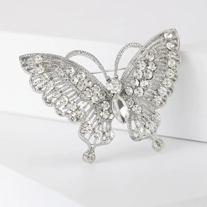 Close-up of vintage butterfly brooch with sparkling crystals and silver hollow wings