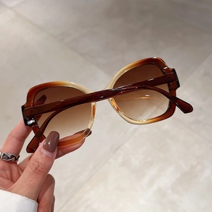 Retro amber sunglasses with brown gradient lenses and stylish translucent square frame