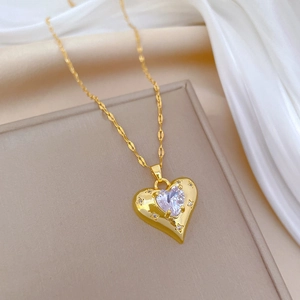 Luxurious gold heart necklace with sparkling crystal pendant on white silk background