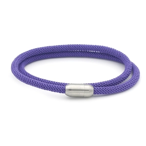 Detail of purple woven double-layer bracelet featuring a magnetic silver metal clasp