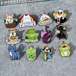 Set of 12 cute cartoon enamel pins with animals and creative motifs on denim background