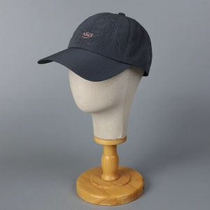 Dark grey plaid baseball cap with orange Nice embroidery on a neutral mannequin head