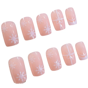 French press-on nails with white snowflake and bowknot patterns on pink base