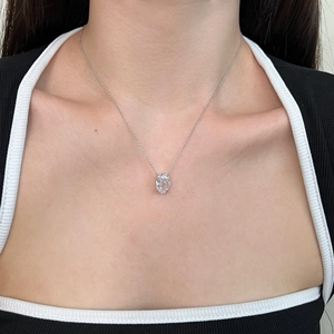 Macro shot of S925 sterling silver necklace with oval ice-cut crystal perfume pendant