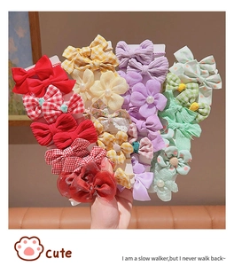 Detailed set of cute colorful bow hair clips with pearls and fabric flowers for girls