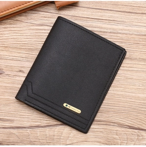 Detail of a slim black leather wallet with fine stitching and metal logo on wood background