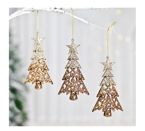 Close-up of glittery hollow Christmas tree pendants with star tops on white branches