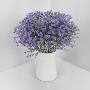Close-up of purple gypsophila bouquet in a white spiral texture ceramic vase