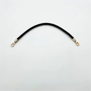Detail of a black PU leather bag handle with gold hooks on a white background