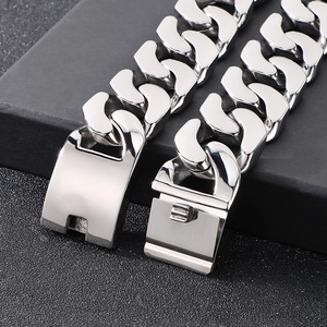 Macro shot of silver stainless steel Cuban chain bracelet with a focus on the buckle clasp