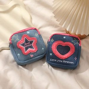 Denim mini cosmetic bags with embroidered star and heart patterns and pink zipper