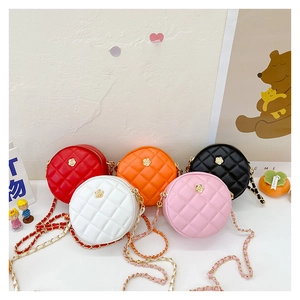 Close-up of five quilted mini round bags in red, white, orange, pink and black PU leather
