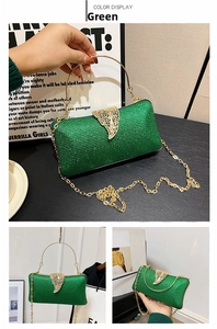 Macro detail of sparkly green evening clutch bag with golden leaf clasp and chain strap