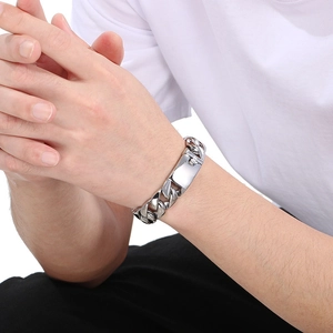 Polished silver titanium steel Cuban link bracelet with clasp on male wrist