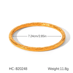 Close-up of golden hollow textured stainless steel bangle with size and weight specs