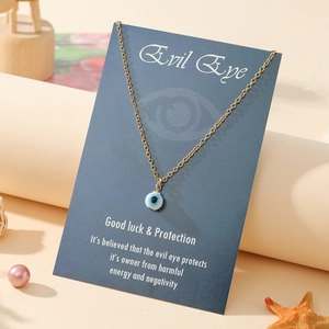 Golden chain Evil Eye pendant necklace presented on descriptive lucky blessing card