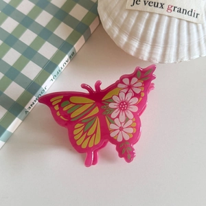 Pink acrylic butterfly hair claw clip with floral patterns for daily styling