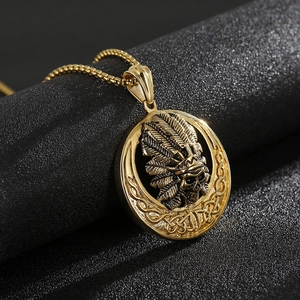 Close-up of golden Indian skull pendant with feather headdress and woven Celtic border